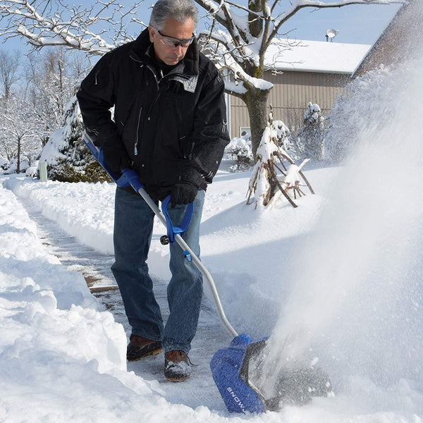 Shovel The Sidewalk And Driveway Before Work With An Electric Snow Shovel